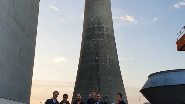 Participants of the THI team stand in front of the nuclear power plant